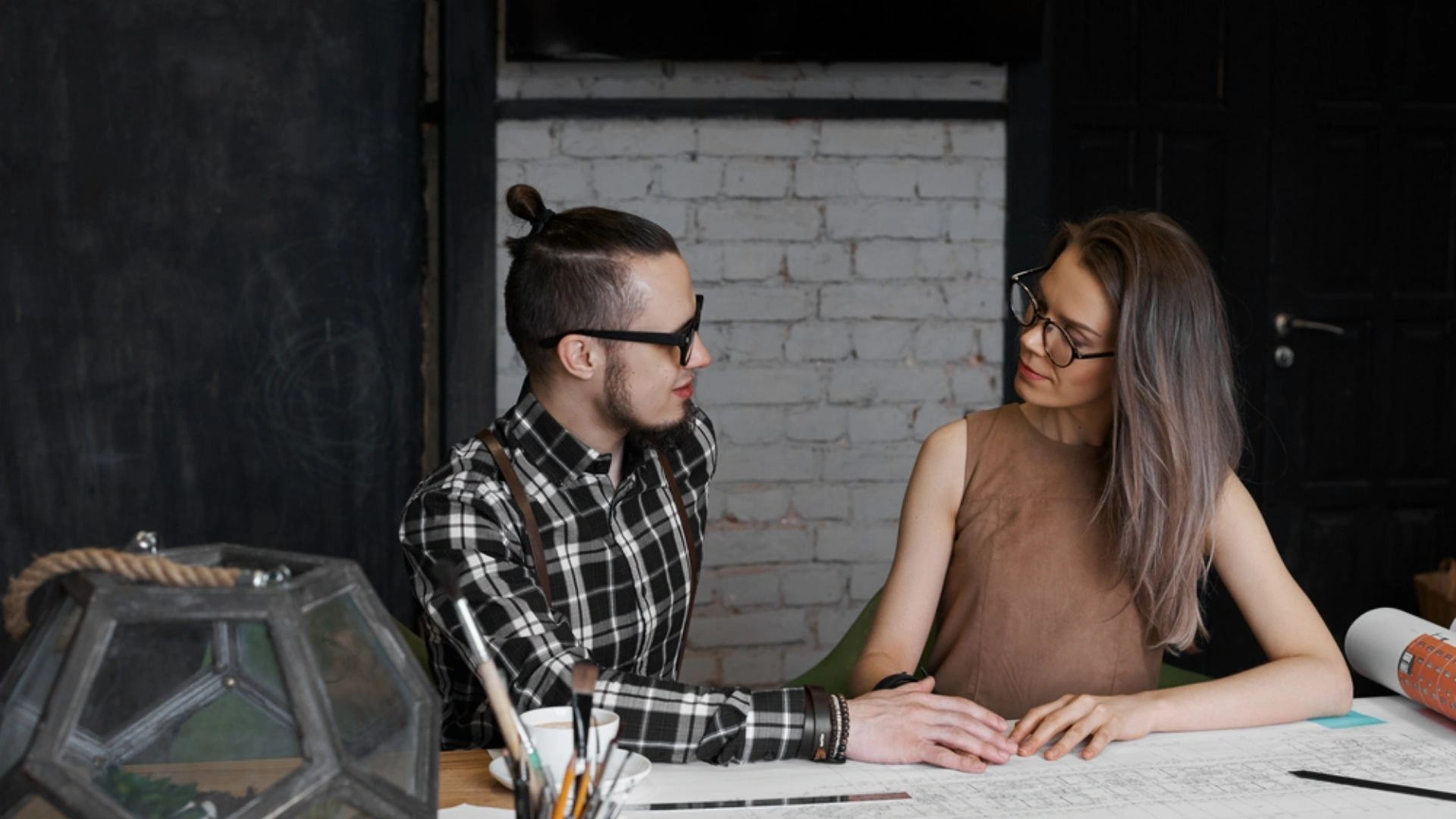 two people looking at each other at a desk