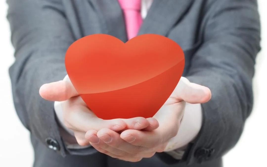 person holding out a toy heart