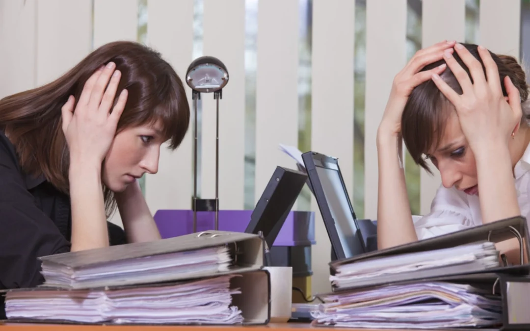 two women holding their heads in their hands