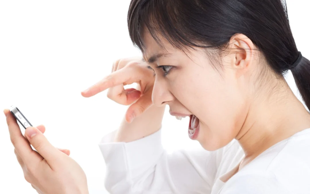 woman angrily sending tweet from her smartphone