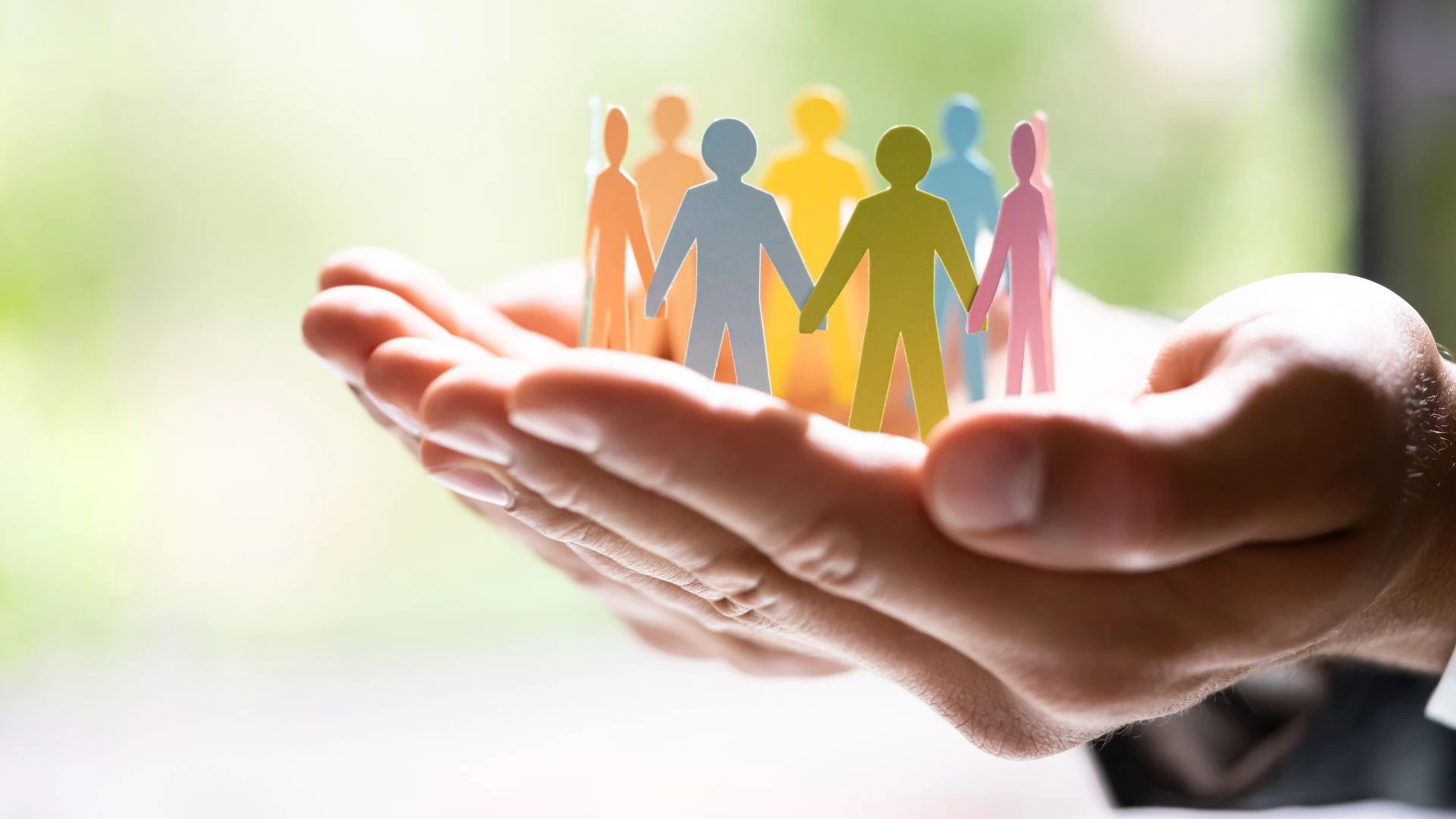 four people with paper bags over their heads spelling out 'team'