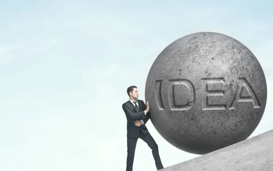 person on hill being pushed by a rock with the word 'idea' on it