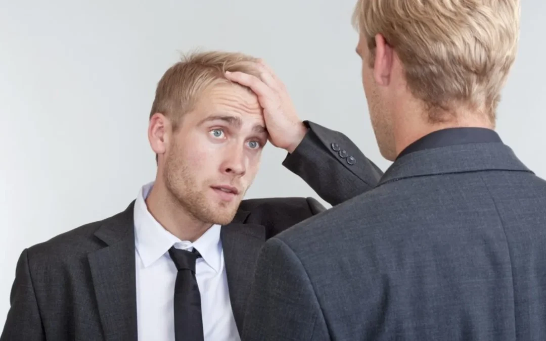 two colleagues talking, one looks frustrated