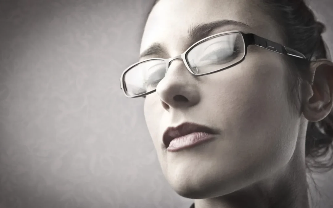 person looking down on someone through their glasses