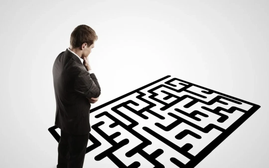 person standing contemplating a maze on the floor