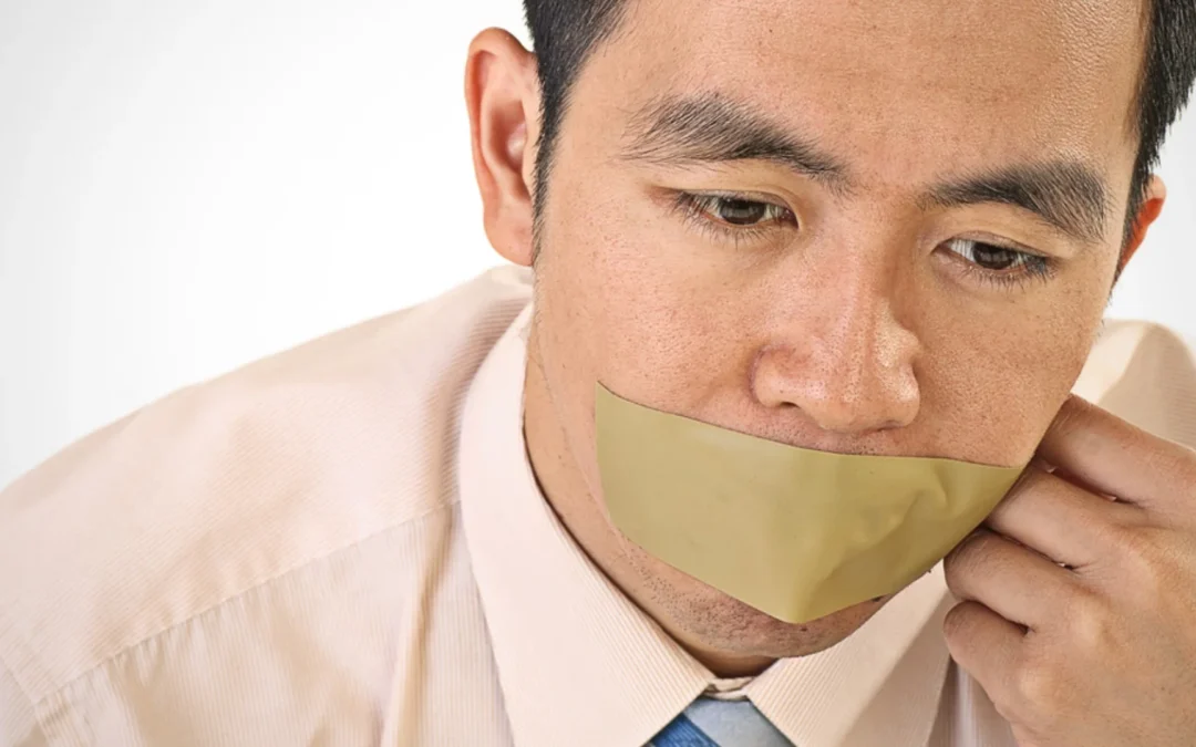 business person with tape covering their mouth