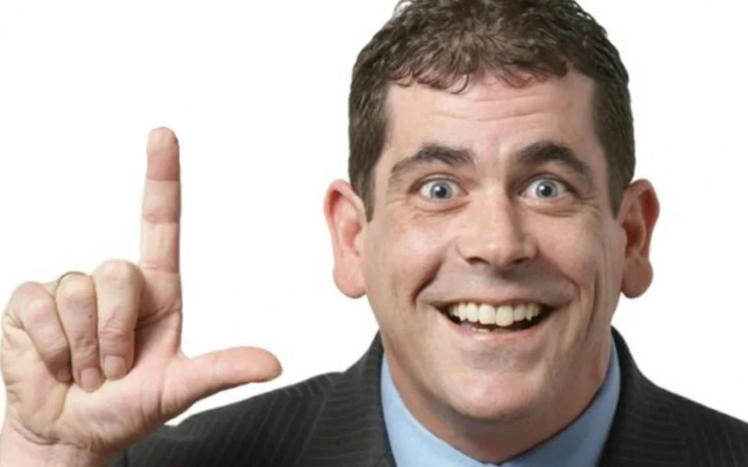 Person holding up their fingers to make an L