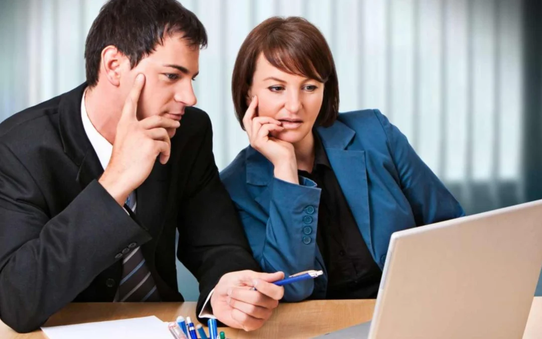 two business people looking at a laptop together