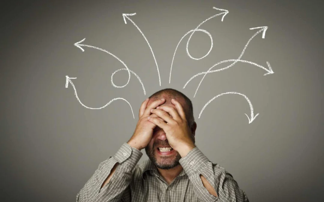 person covering their face while spiral arrows surround their head