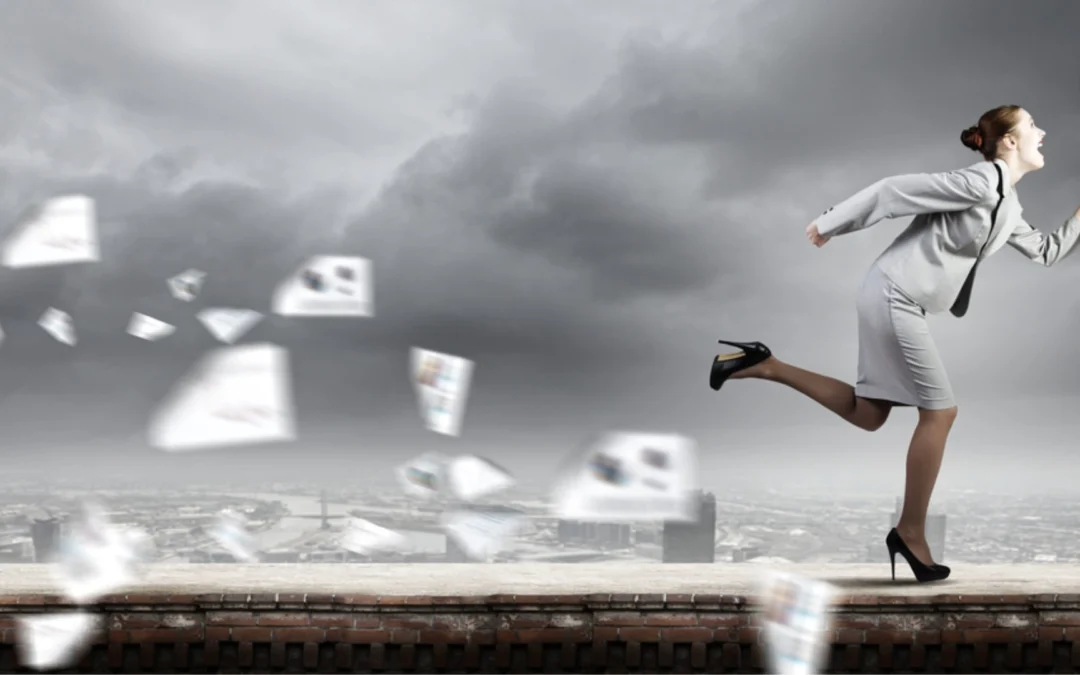 person running from a flurry of papers