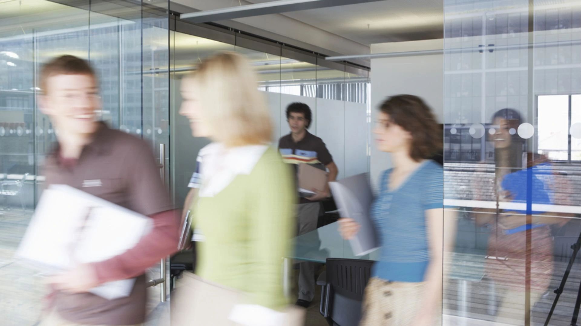 people leaving a meeting room