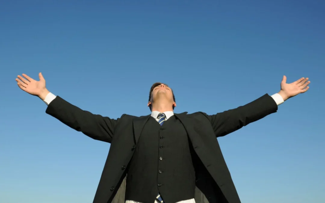 person standing with his arms spread up to the sky