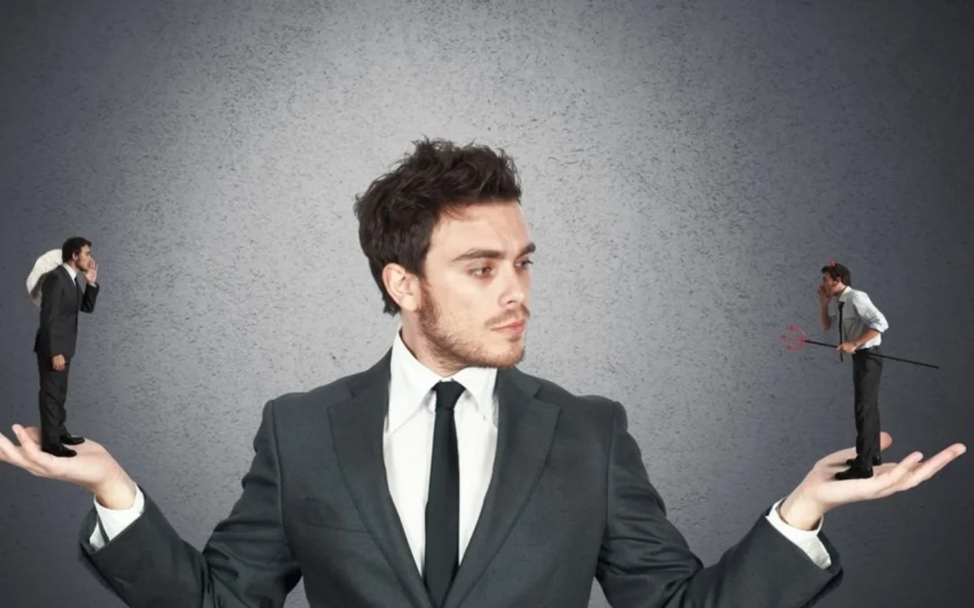 person balancing a devil in one hand and an angel in the other