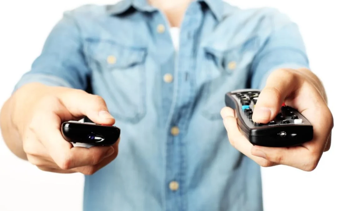 person holding two remote controllers