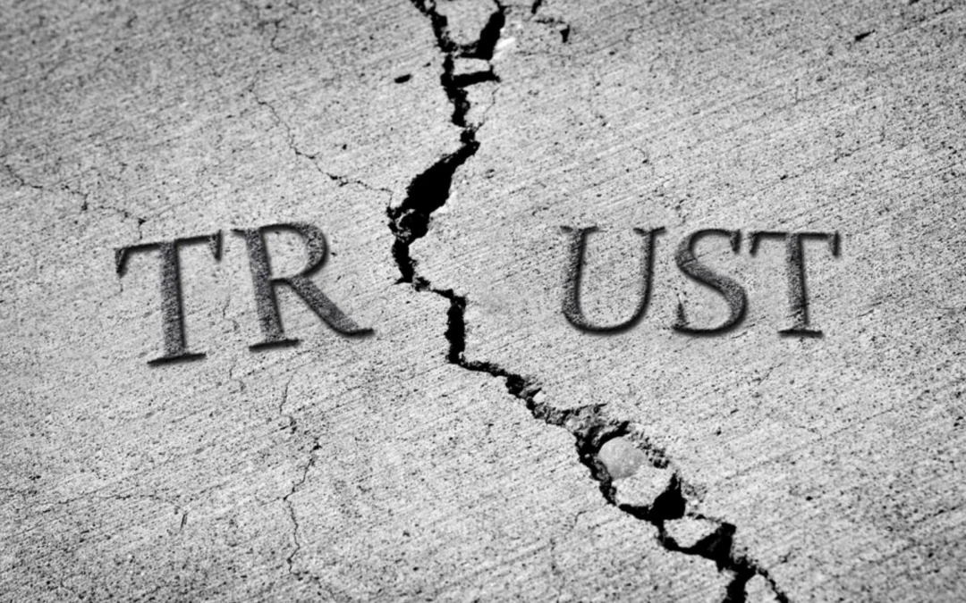 'trust' written on cracking pavement