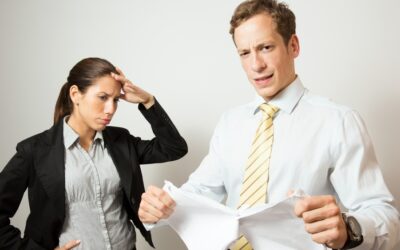 one person giving feedback to another, who looks stressed