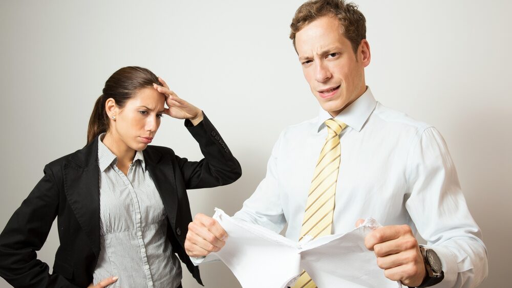 one person giving feedback to another, who looks stressed