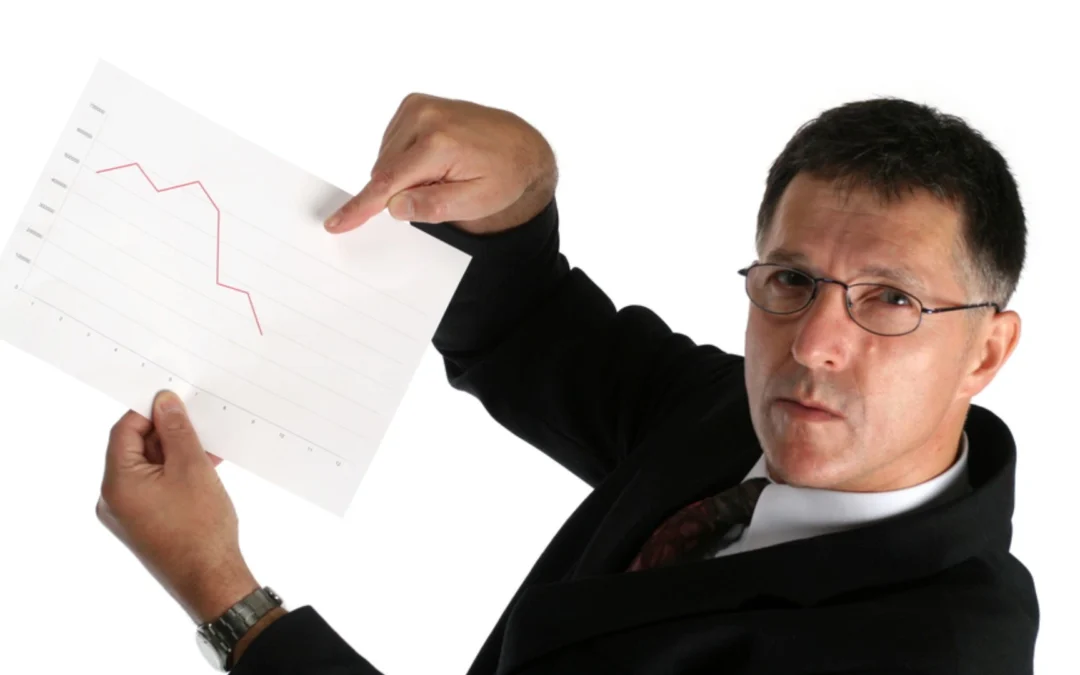 person holding a chart with trends going down