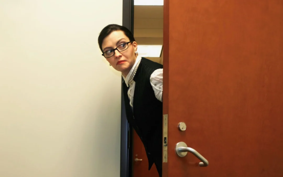 person sneaking around an office