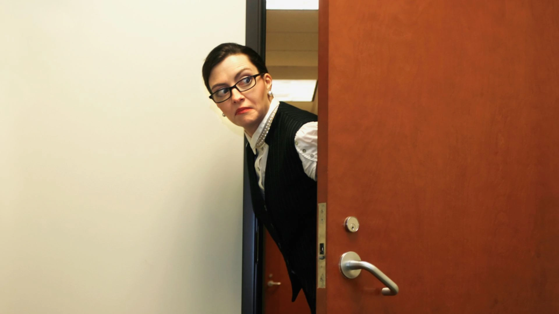 person sneaking around an office