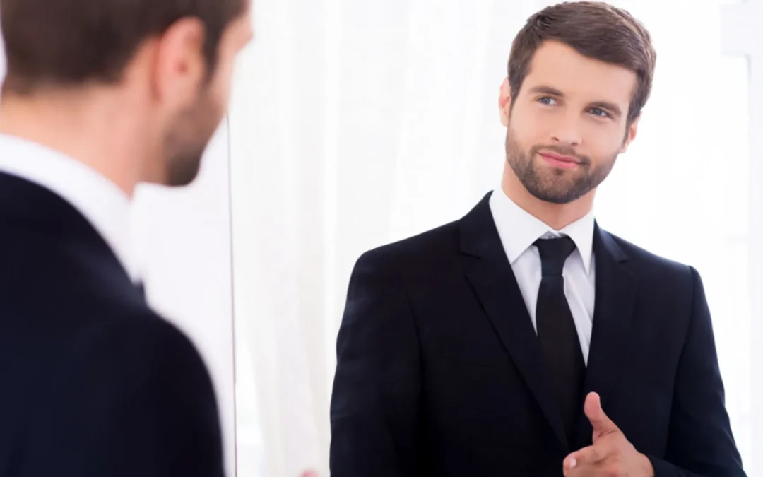 person shooting finger guns at themselves in the mirror