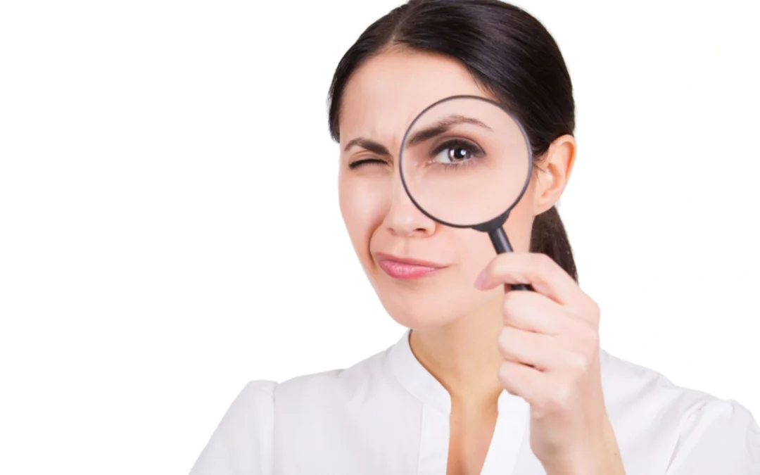 person looking through a magnifying glass