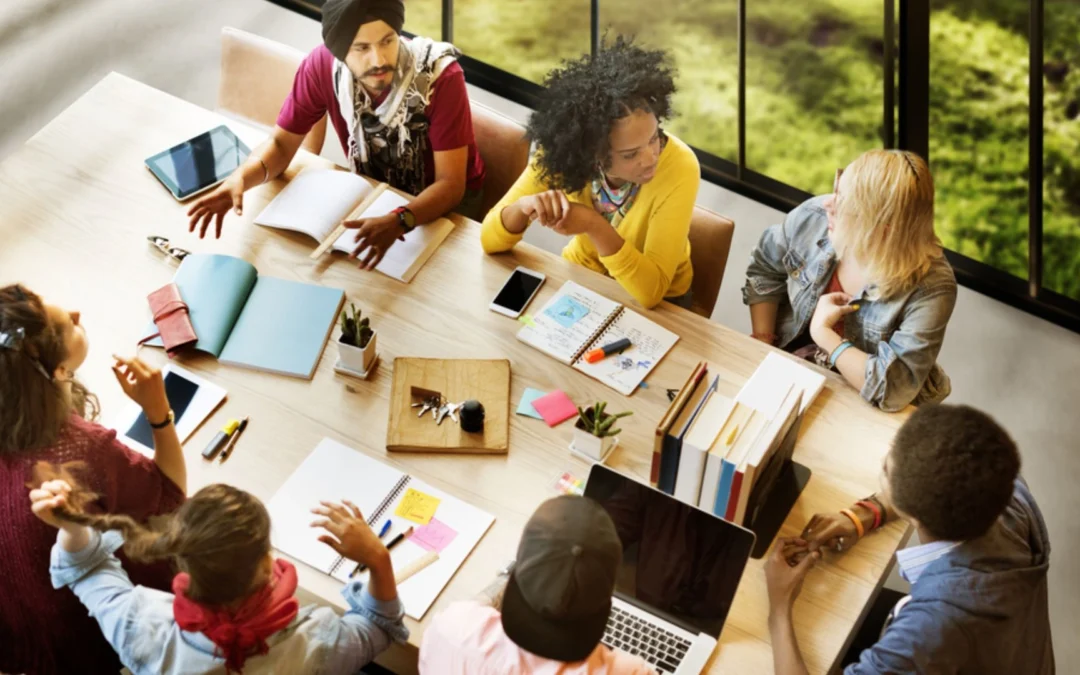 group of teammates sitting around a table