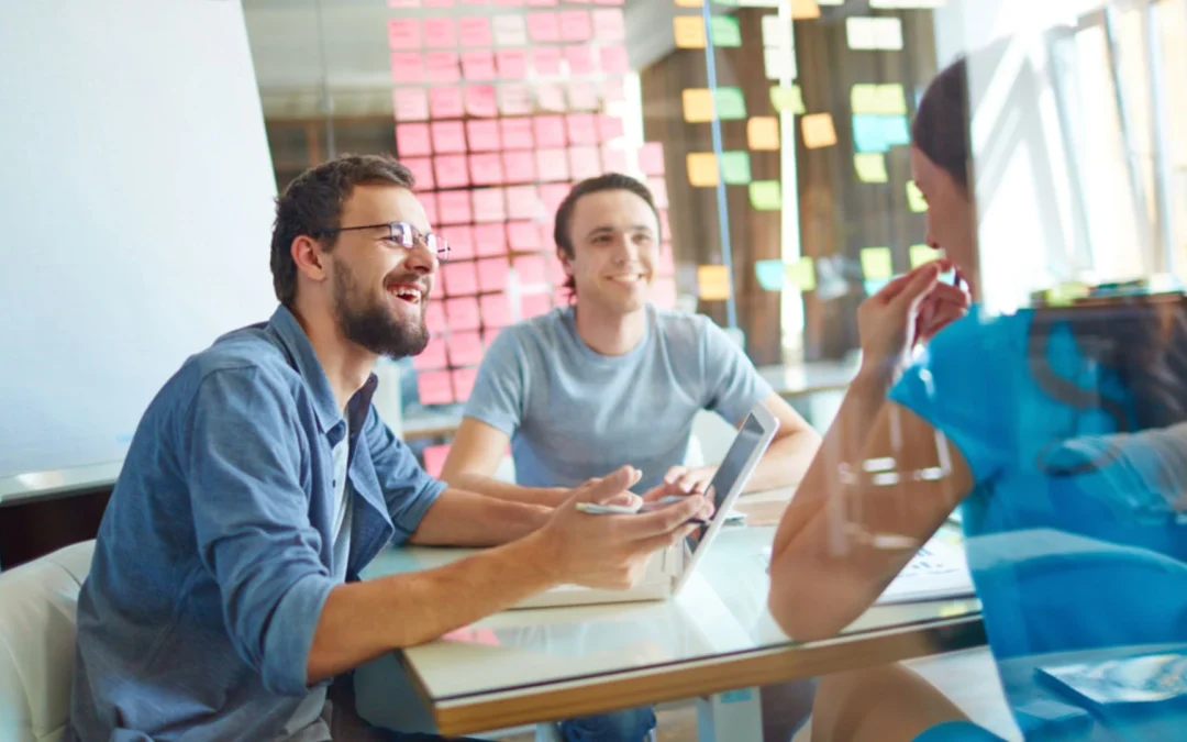 people gathered with sticky notes on the wall
