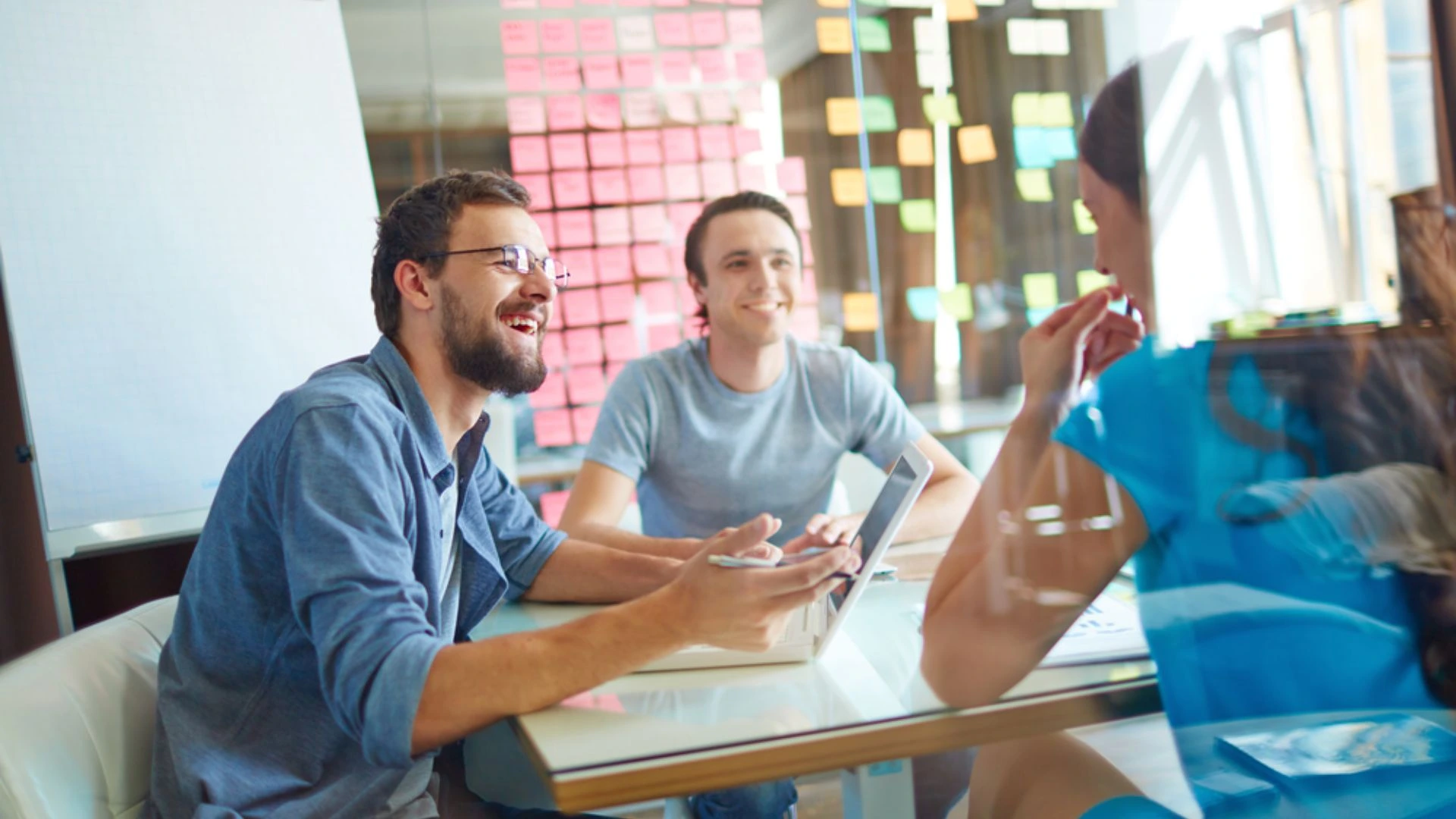 people gathered with sticky notes on the wall