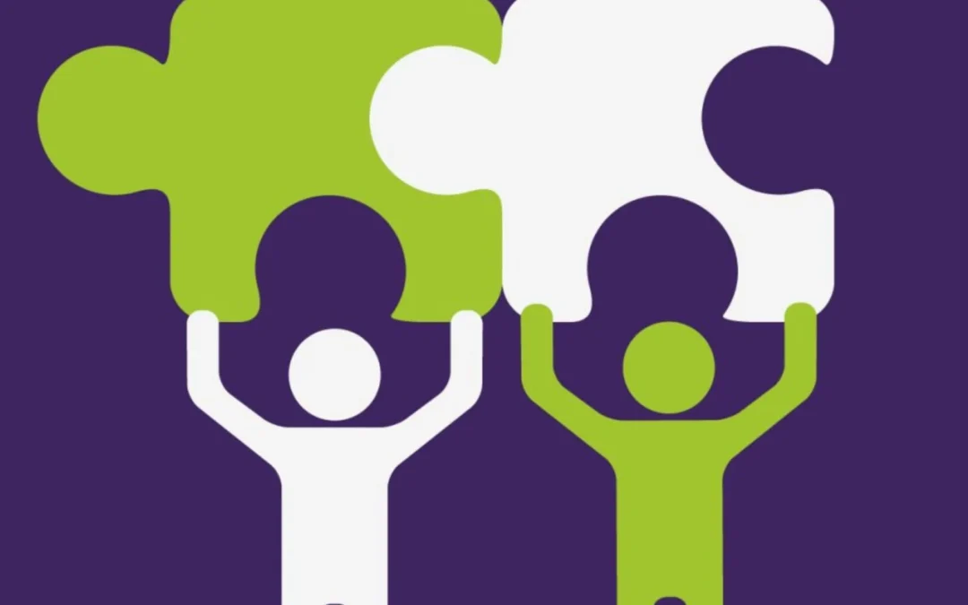 Two people connecting puzzle pieces