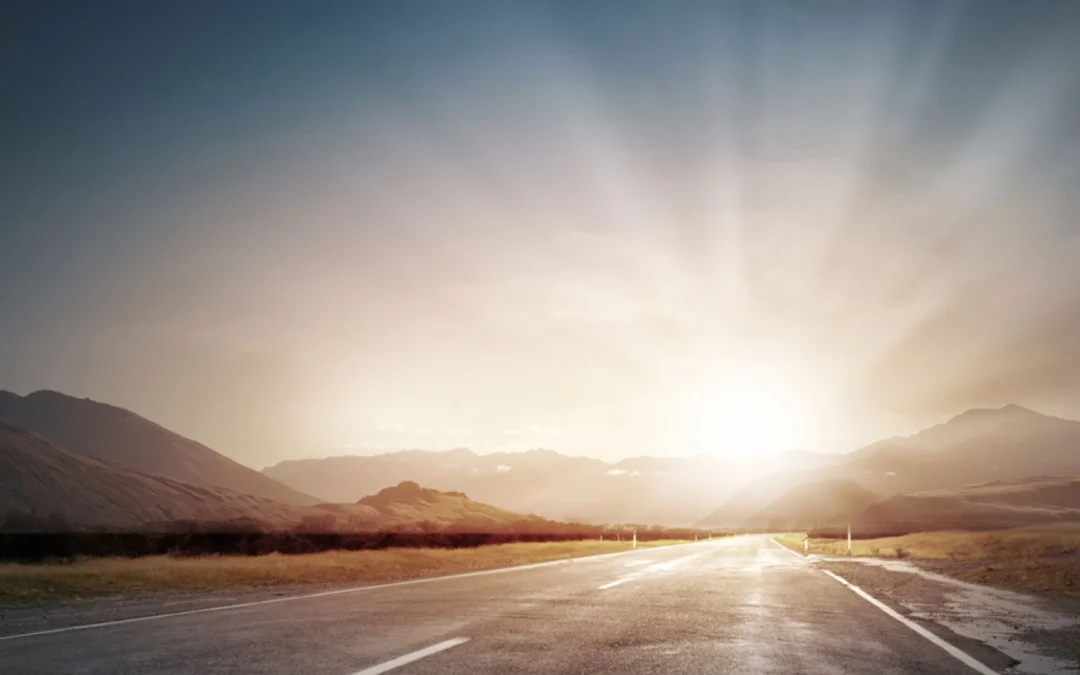 Dawn breaking over a long highway