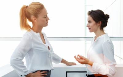 Two people standing face to face talking