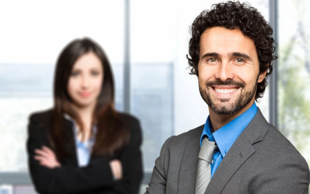 Two business people, one smiling, one concerned