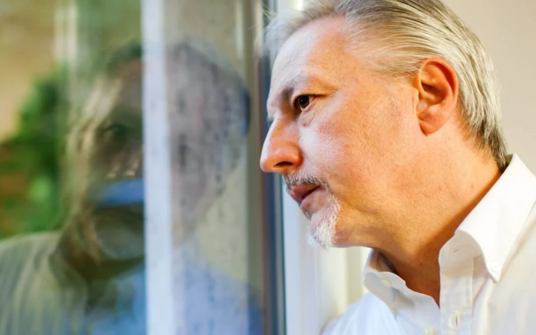 Person outside of a meeting room looking in