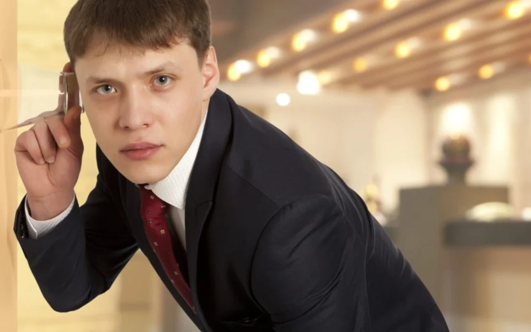 Person using glass to listen at a door