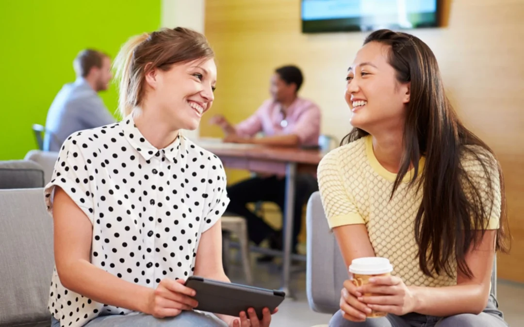 Two people sitting casually in an office talking