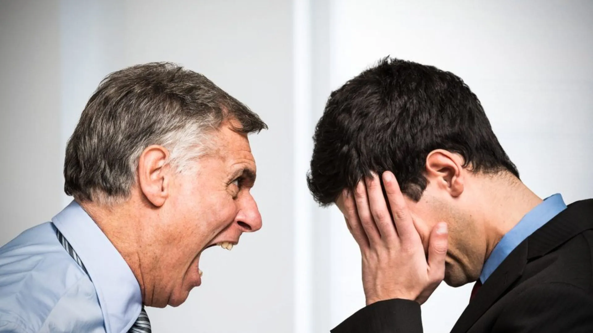 Boss yelling at a person who has his head in his hands