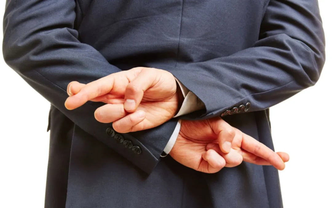 Person with fingers crossed behind back