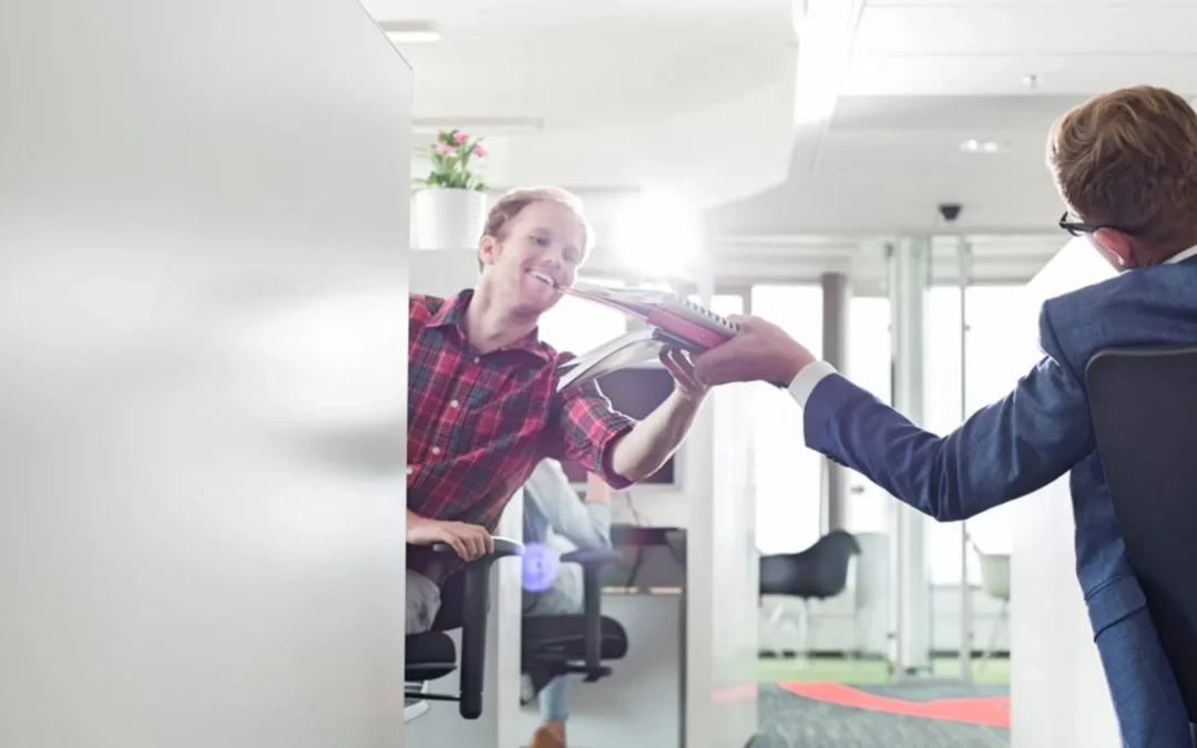 Person passing a file to employee