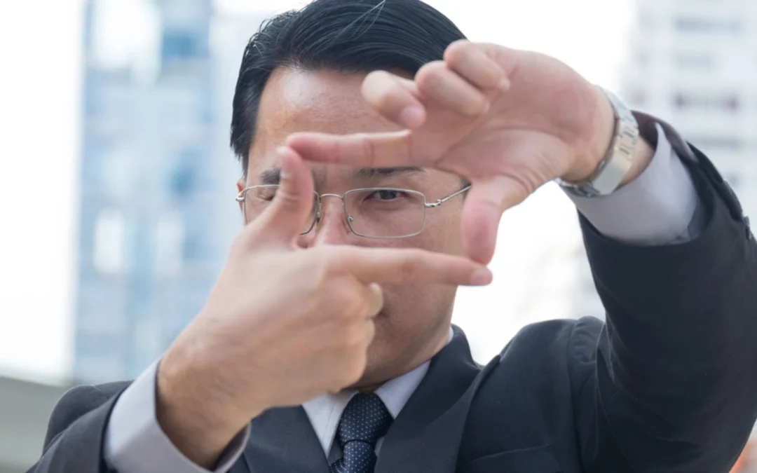 Person holding up fingers in a frame to look through