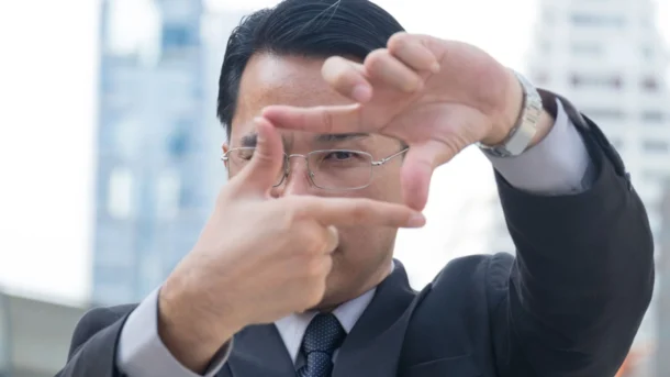 Person holding up fingers in a frame to look through