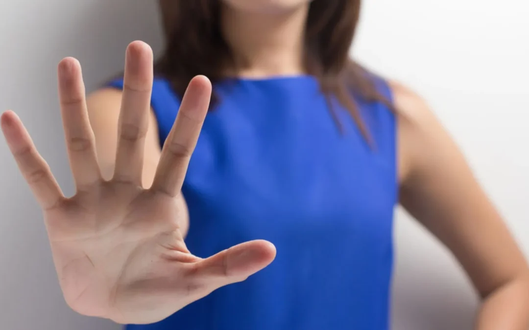 Woman holding up her hand saying "no"