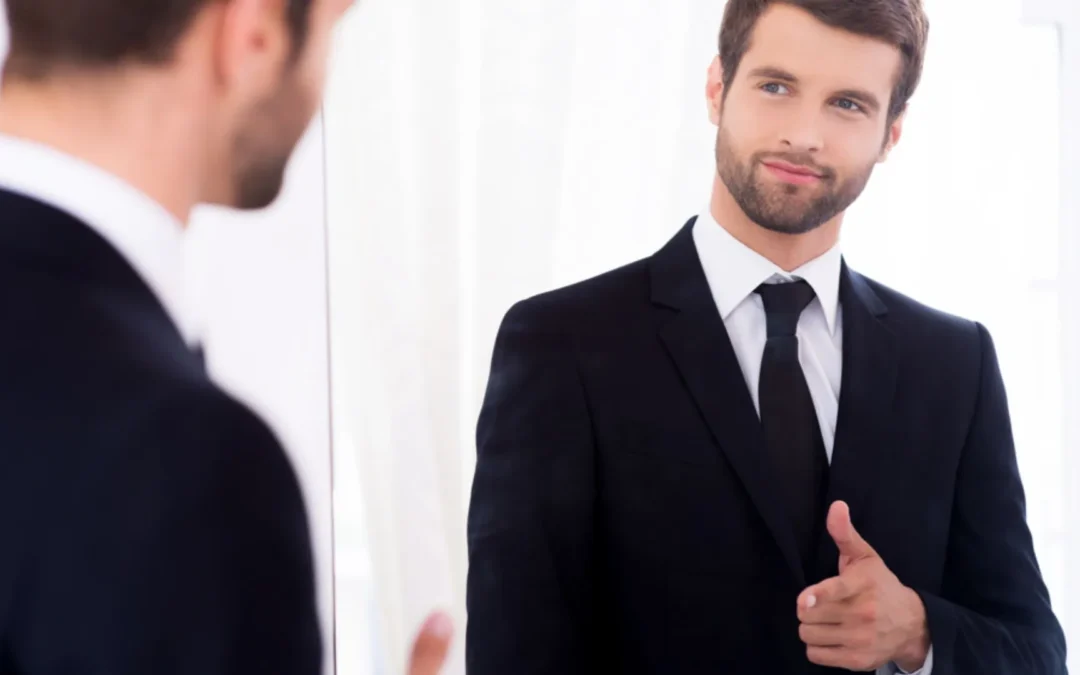 Person looking in the mirror, giving himself the thumbs up