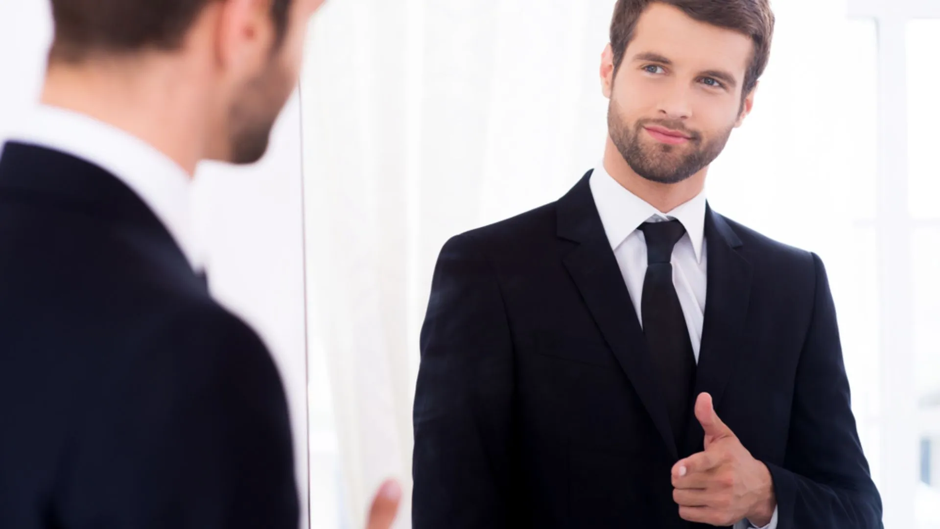 Person looking in the mirror, giving himself the thumbs up