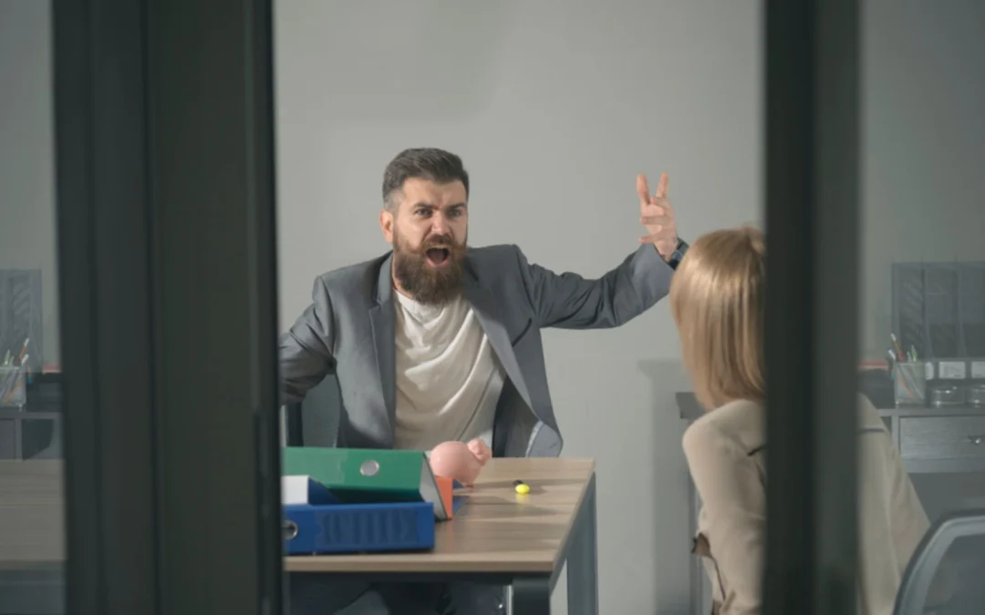 Looking into an office where a boss is yelling at an employee