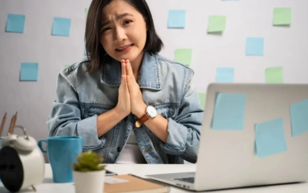 Woman working from home, hands together asking for foregiveness