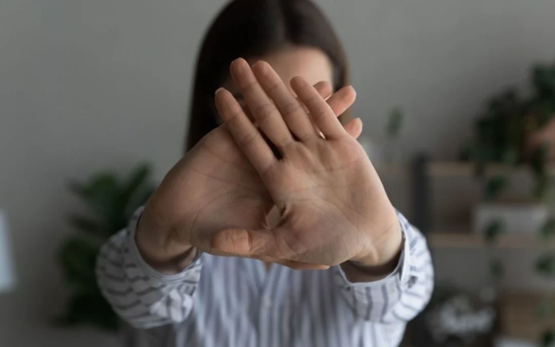 Person holding up hands to say "no"
