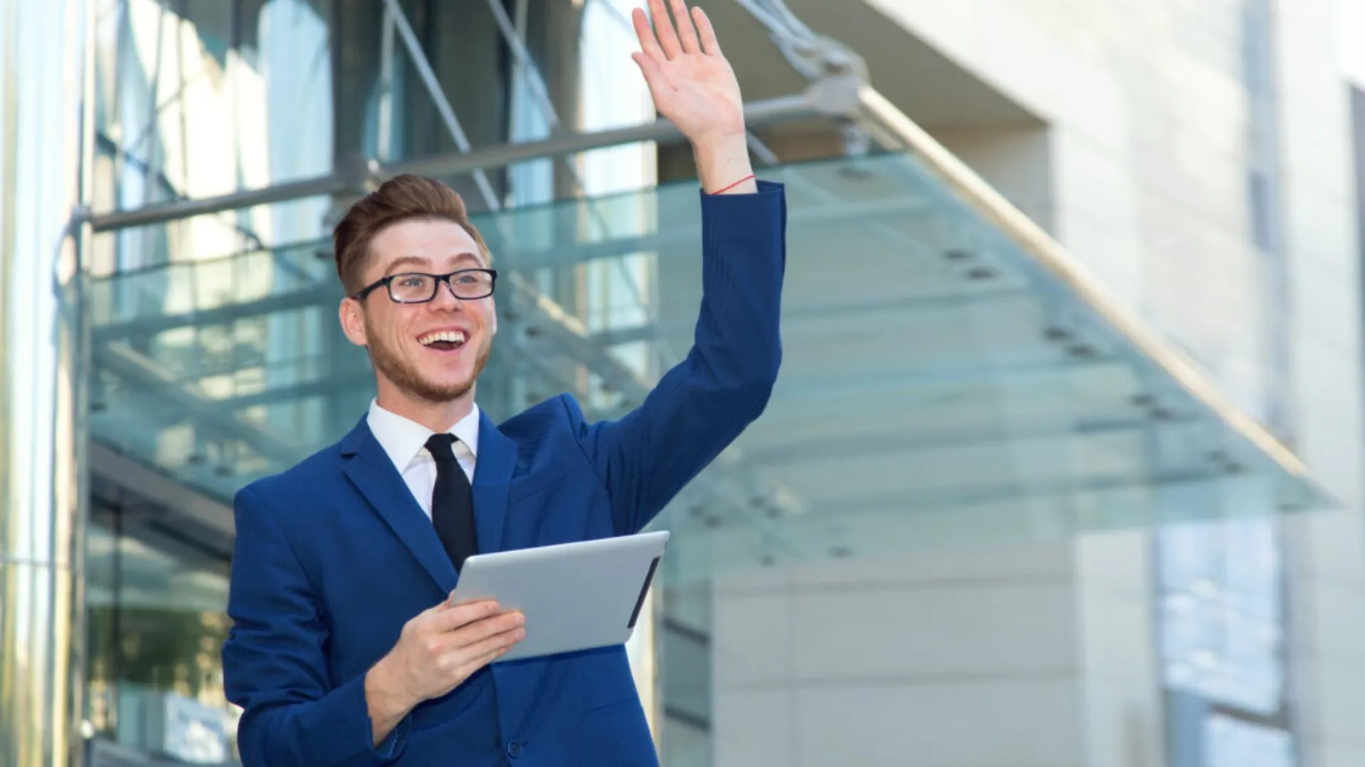 Young man waving from a distance