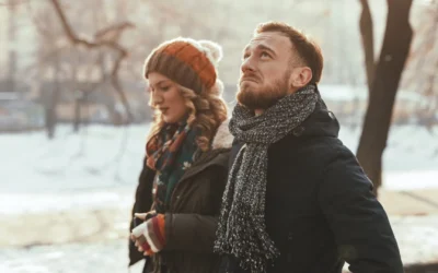 Couple walking outside, not talking to each other