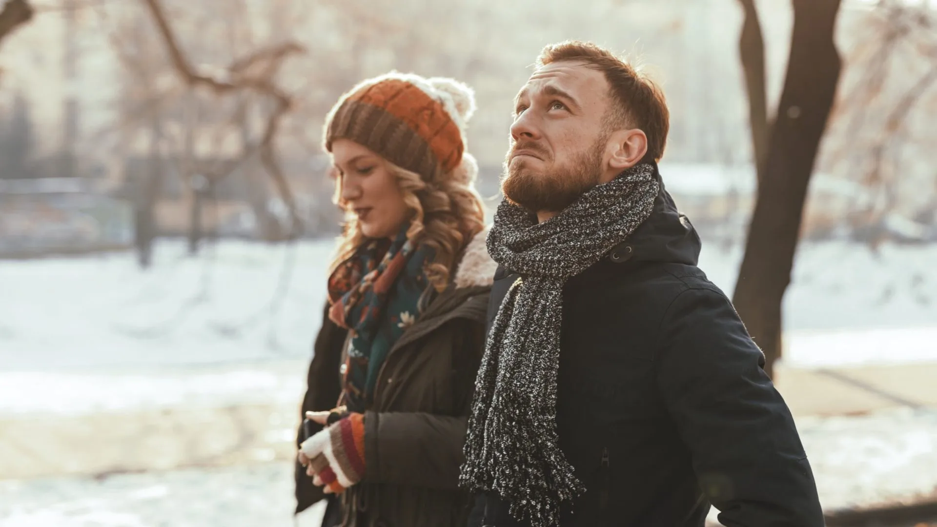 Couple walking outside, not talking to each other